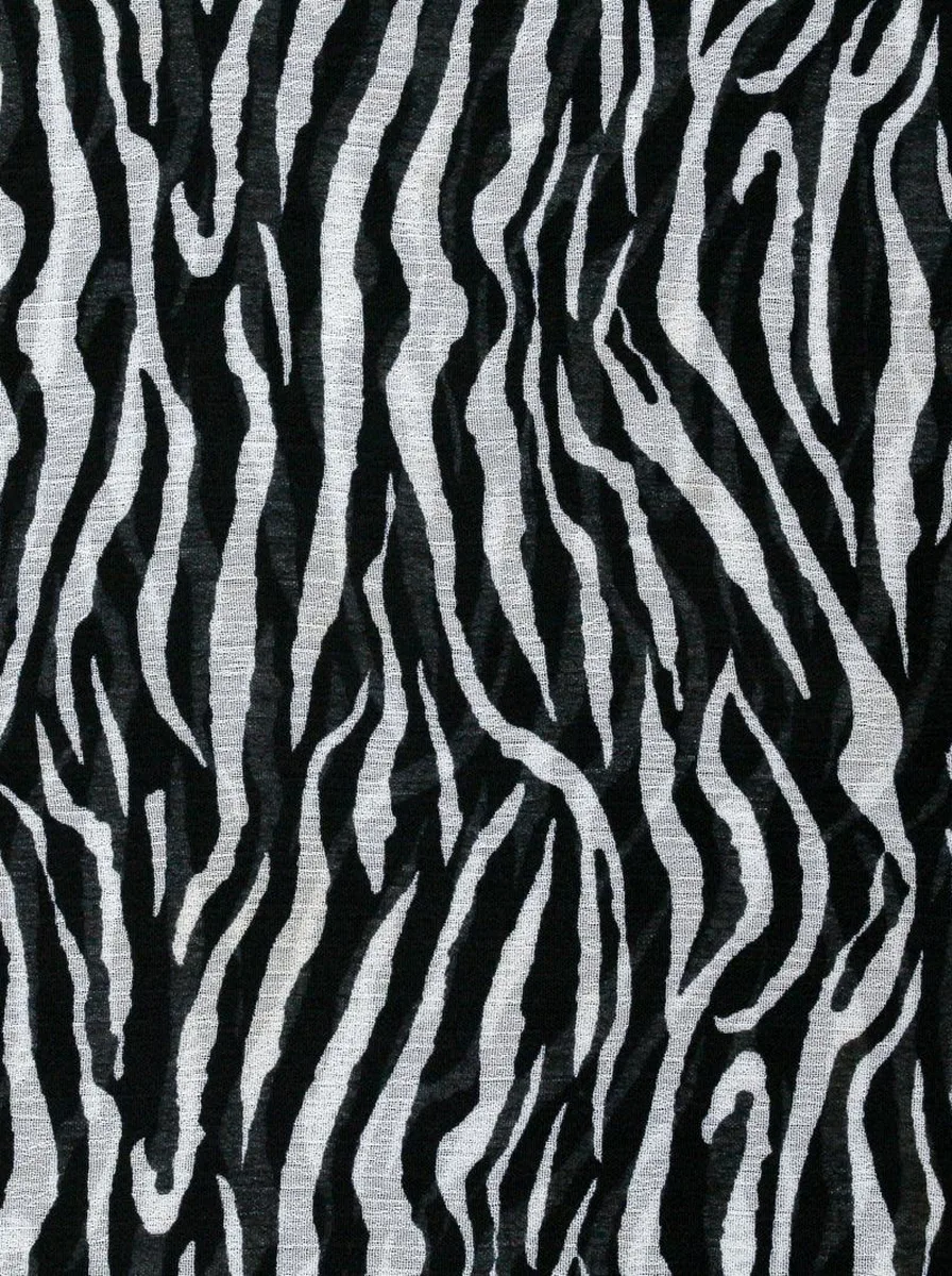 Dramatic evening lighting washing over animal print accent wall