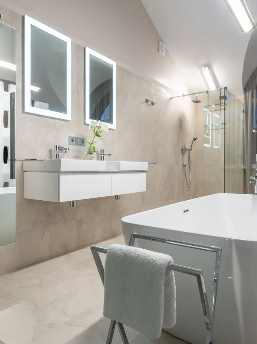 Backlit LED mirror glowing in an elegant bathroom