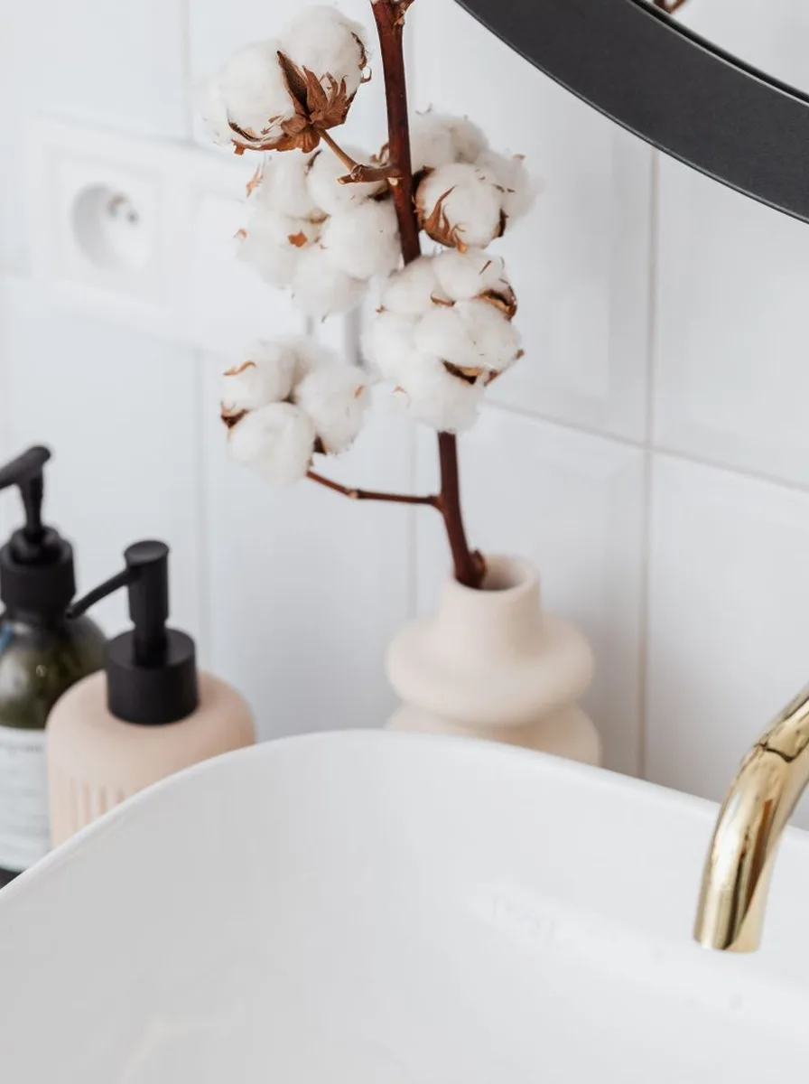 Magnetic strip holding tweezers and bobby pins in bathroom