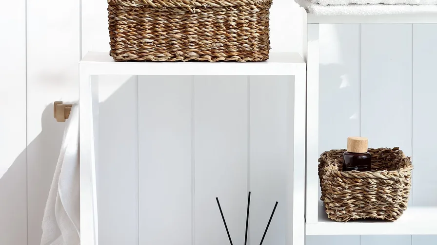 Neatly organized bathroom with labeled storage baskets and trays