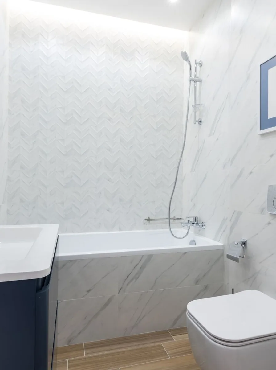 Ladder shelf leaning in bathroom corner with towels