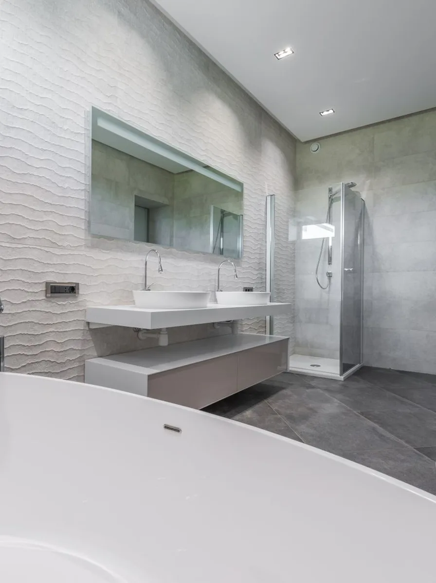 Narrow pull out tower cabinet beside vanity