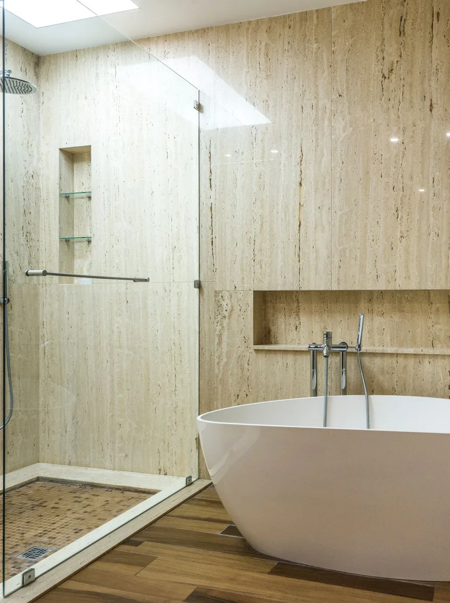 Wall mounted drying rack with shelf above in bathroom