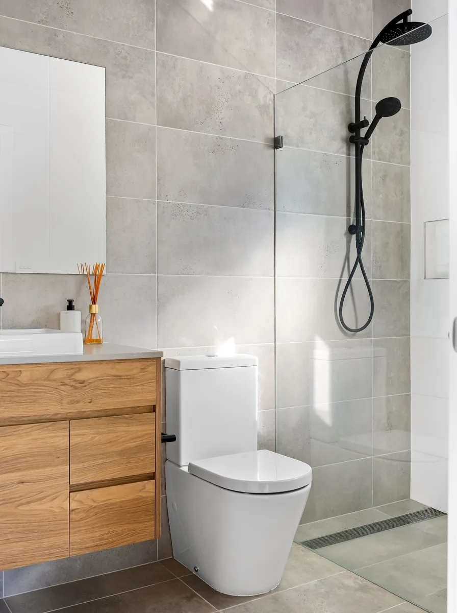Under-sink vanity cabinet with pull-out organizers fitted around plumbing