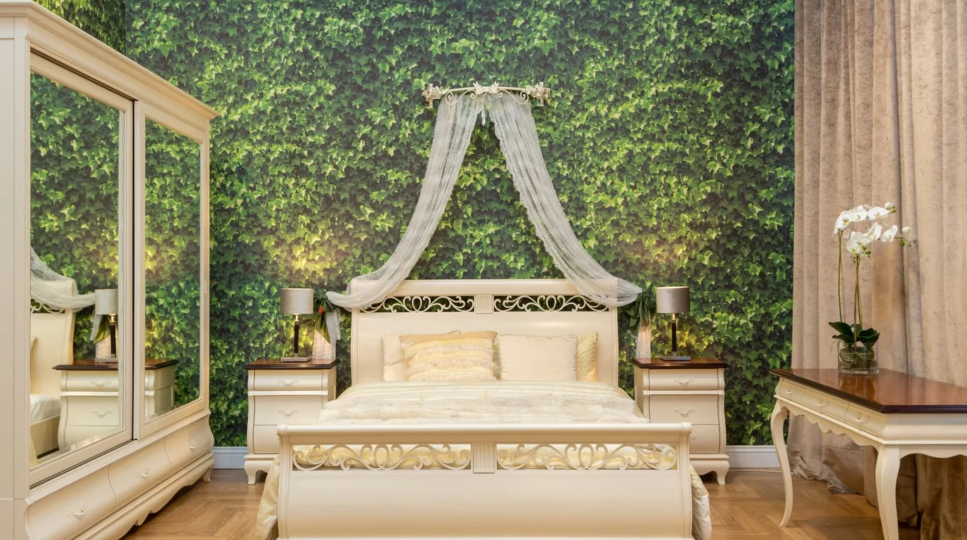 Bedroom with green accent wall and white bed, a fresh colour combination