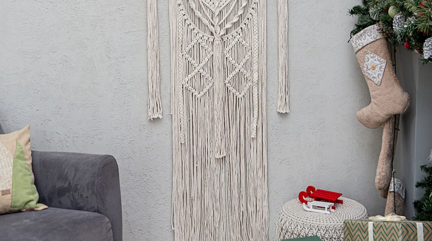 Dreamy boho wall with macrame, plants and layered textiles