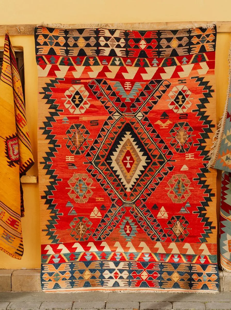 Rugs on the floor against walls, boho wall idea