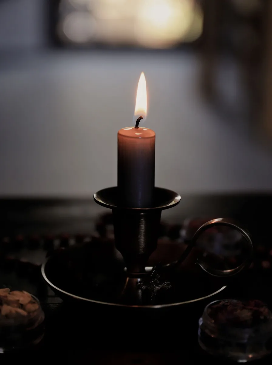 Black metal tray with assorted black candle holders on a coffee table