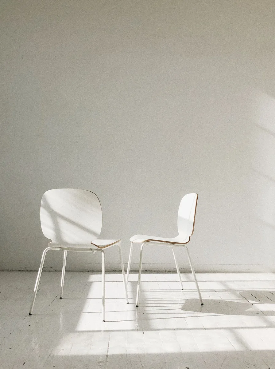 Minimalist white chair in a clean workspace