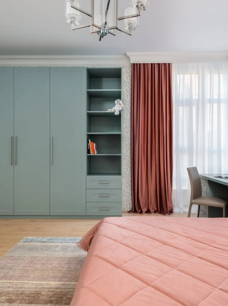 Fresh bedroom with mint green wardrobe, coral curtains, and pink bedding