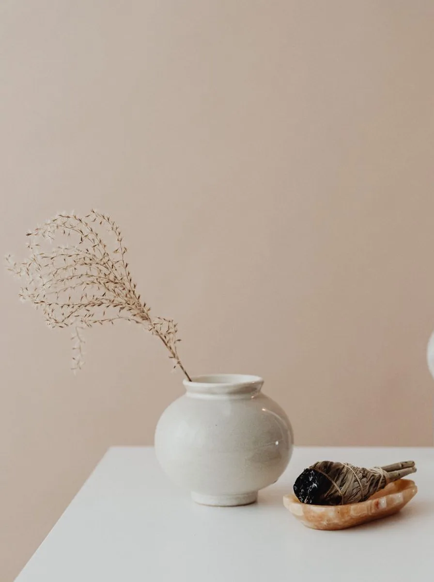 Small floating candle holders hanging on a kitchen open shelf with glassware
