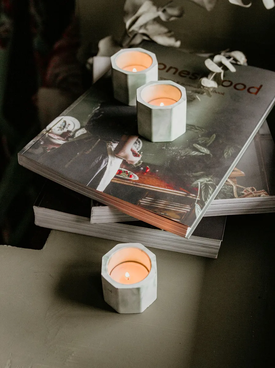 Tall statement floor candle holders in matte black standing in a living room corner