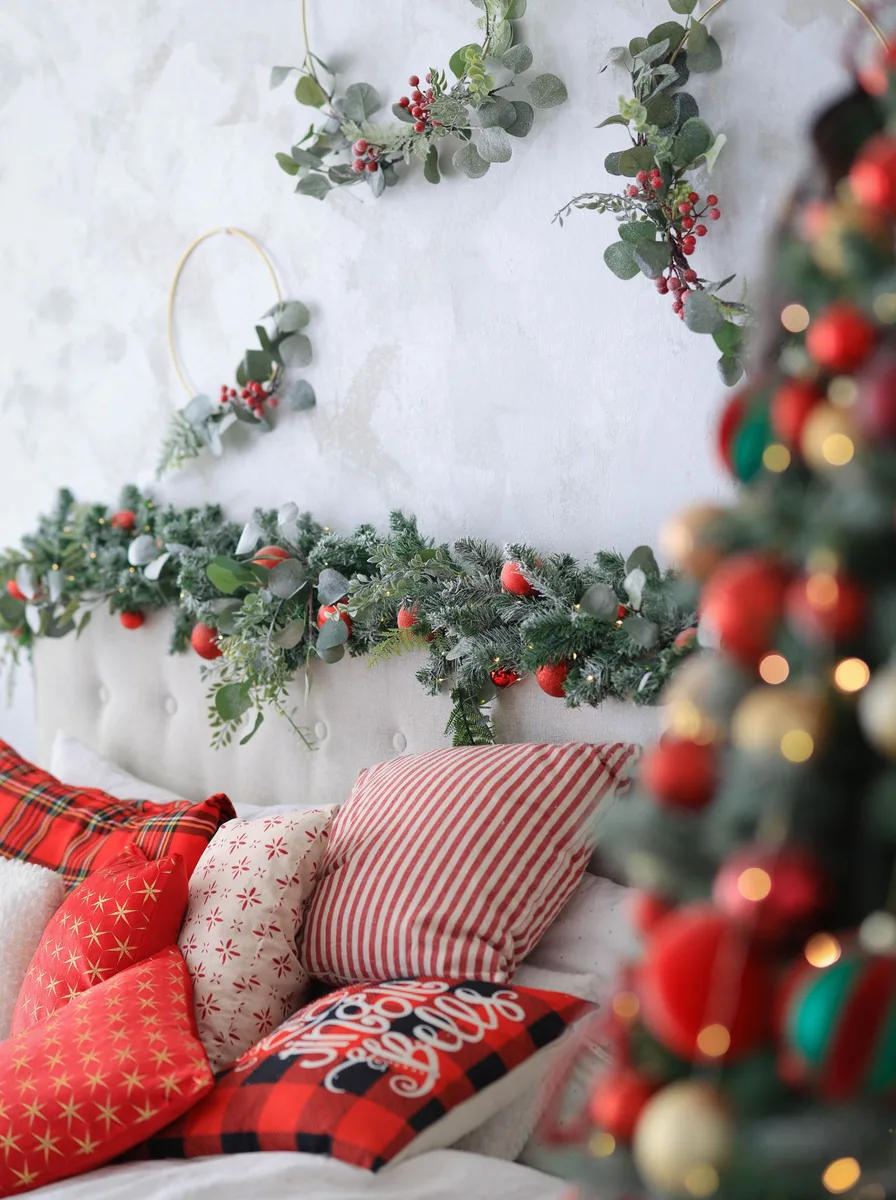 Bedroom headboard wrapped in warm twinkling fairy lights