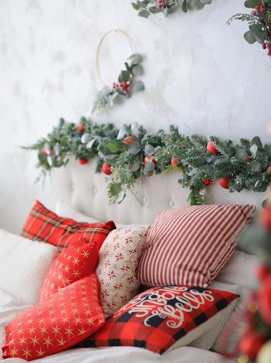 Small decorated Christmas tree glowing in a bedroom corner