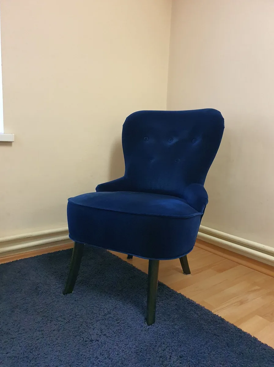 Desk chair tucked under a wooden desk