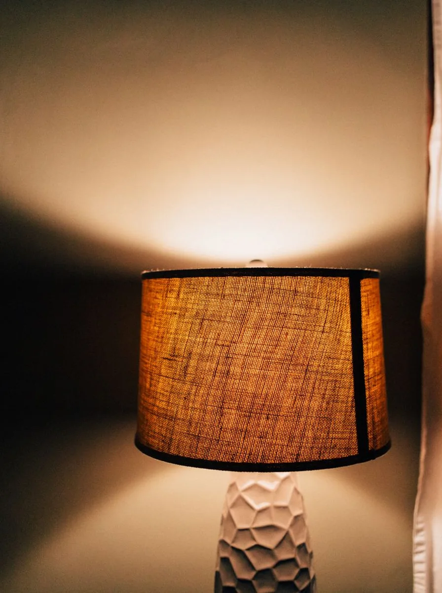 Small lamp on desk in dark room