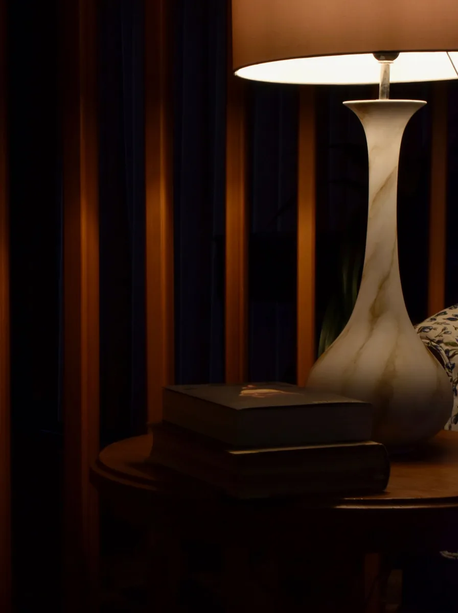 Dark bedroom with sculptural table lamp