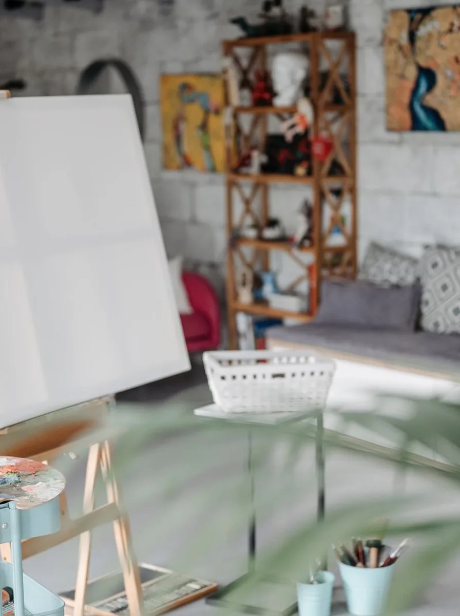 Eclectic cluster of colourful canvases and frames in a bright art studio corner