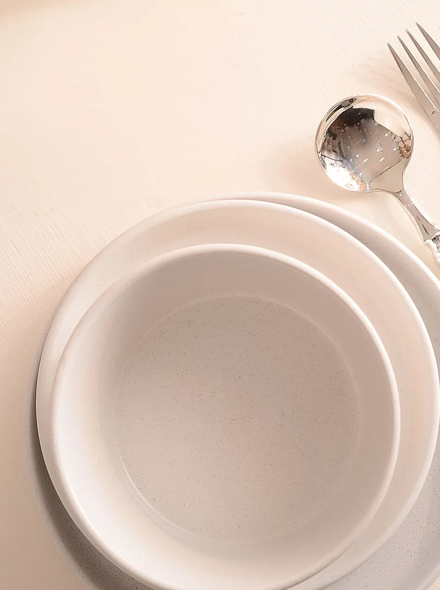 Flawless simple ceramics and glassware on a minimalist dinner table
