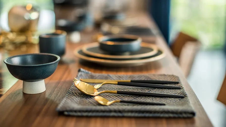 Minimalist dinner table styled effortlessly with clean simple place settings