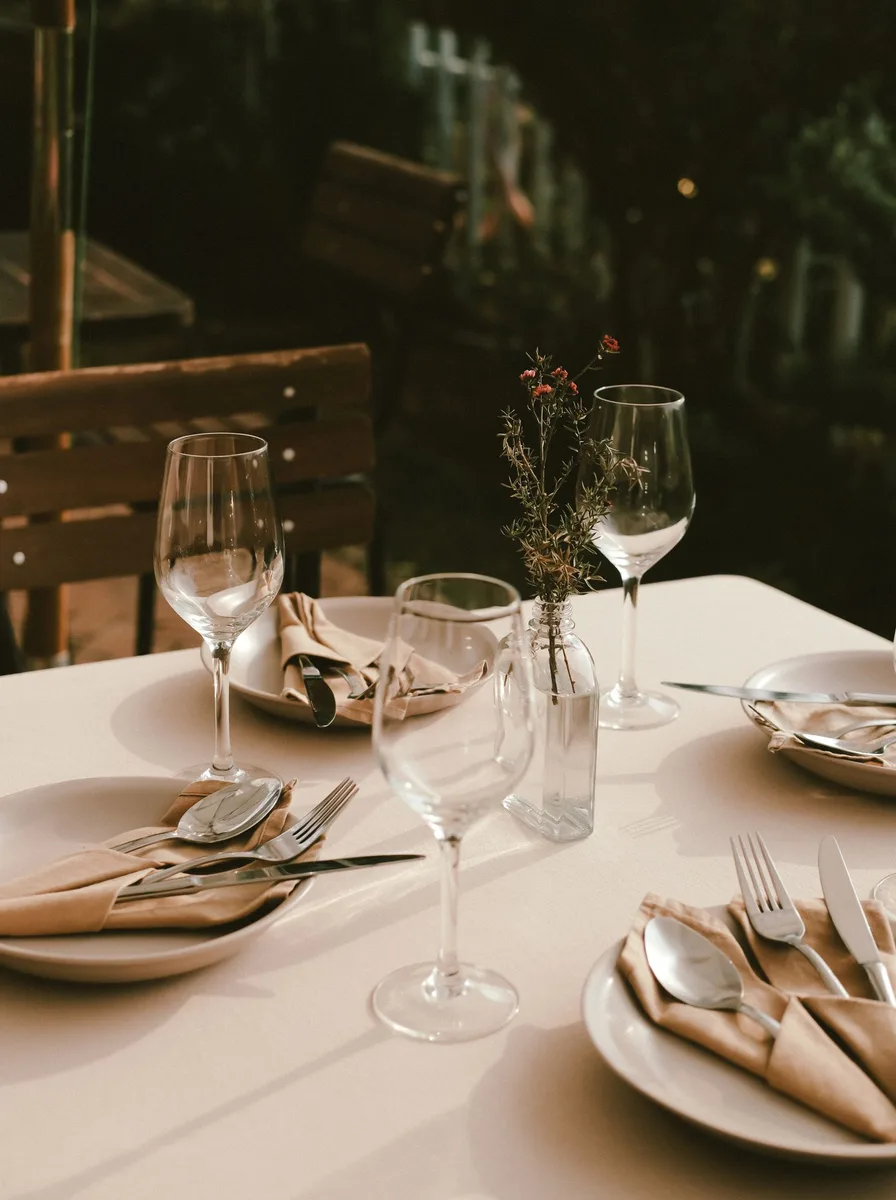 Quality dinner table basics with white plates cloth napkins and clear glassware