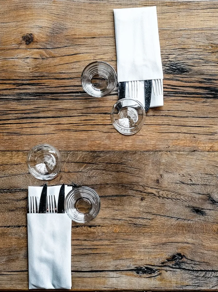 Simply layered dinner table with placemat charger and folded napkin