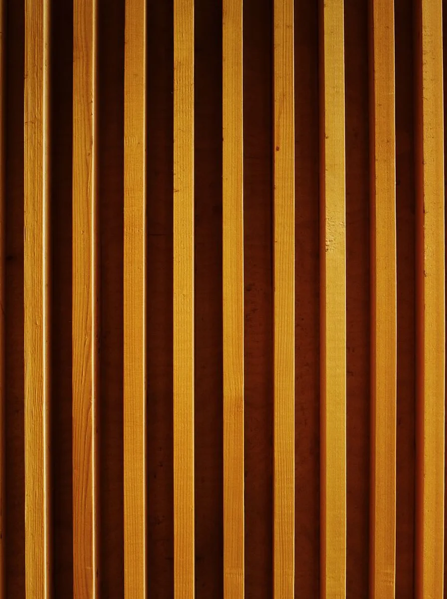 Vertical wood slat feature wall in warm oak tones