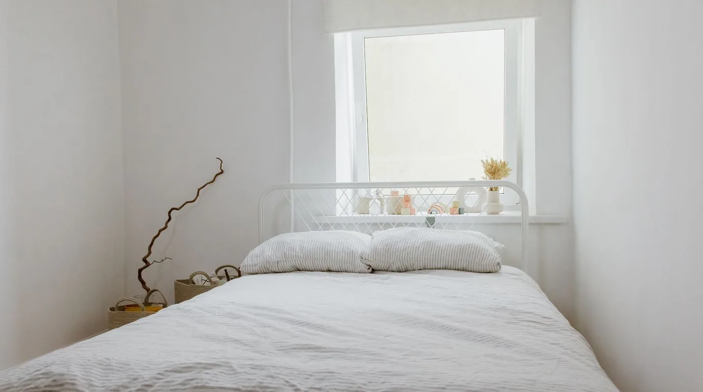 Bright and airy all-white bedroom flooded with daylight