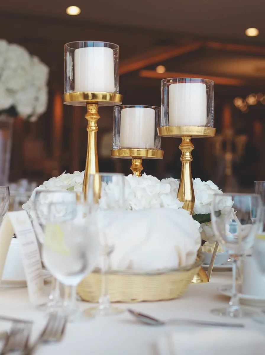 Small gilded candle holders styled among dishes on open kitchen shelves