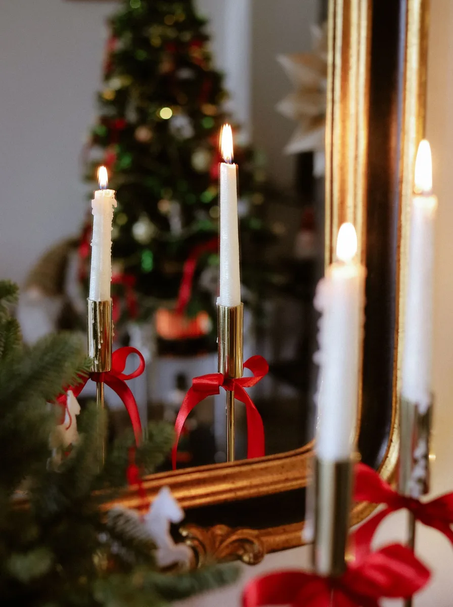 Cluster of gold candle holders in various heights arranged on a fireplace hearth