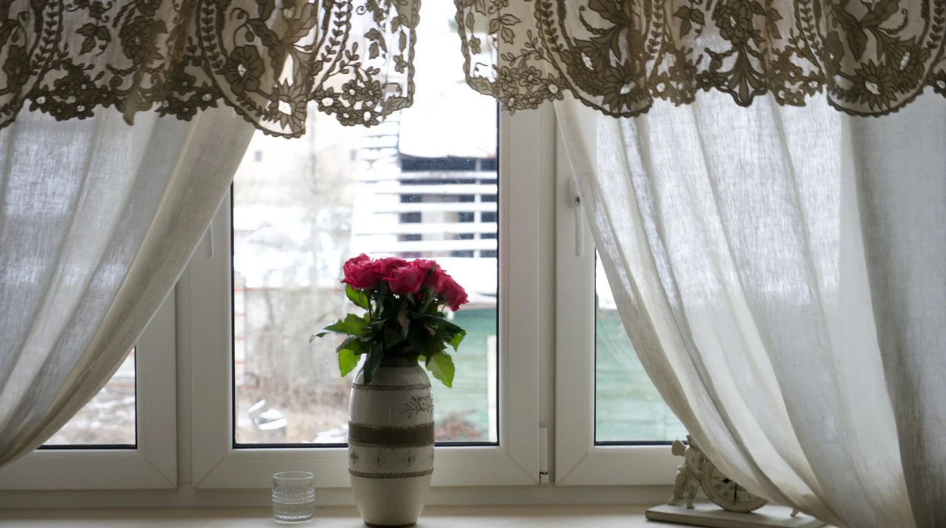 Charming kitchen window dressed with pretty curtains