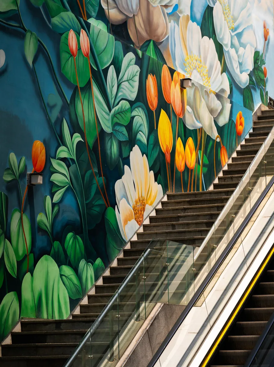 Massive floral mural painted on a stairway wall