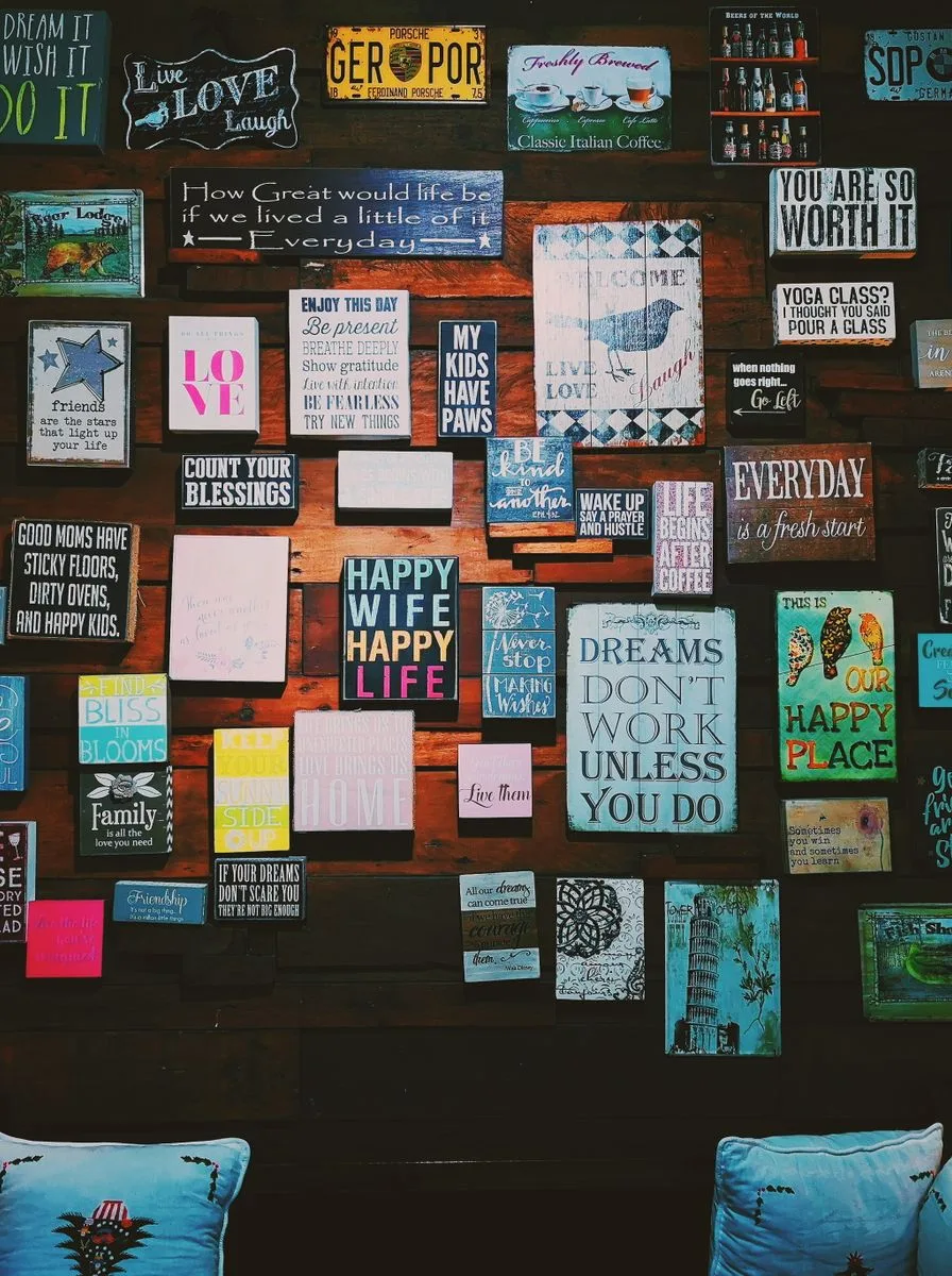 Wall covered in colourful poster-sized quote frames