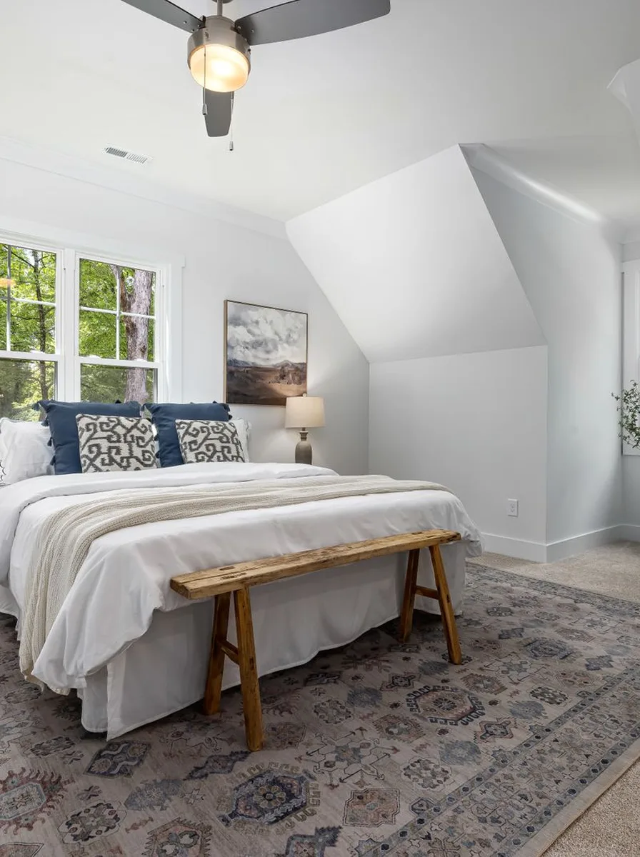 Bright attic bedroom with bench