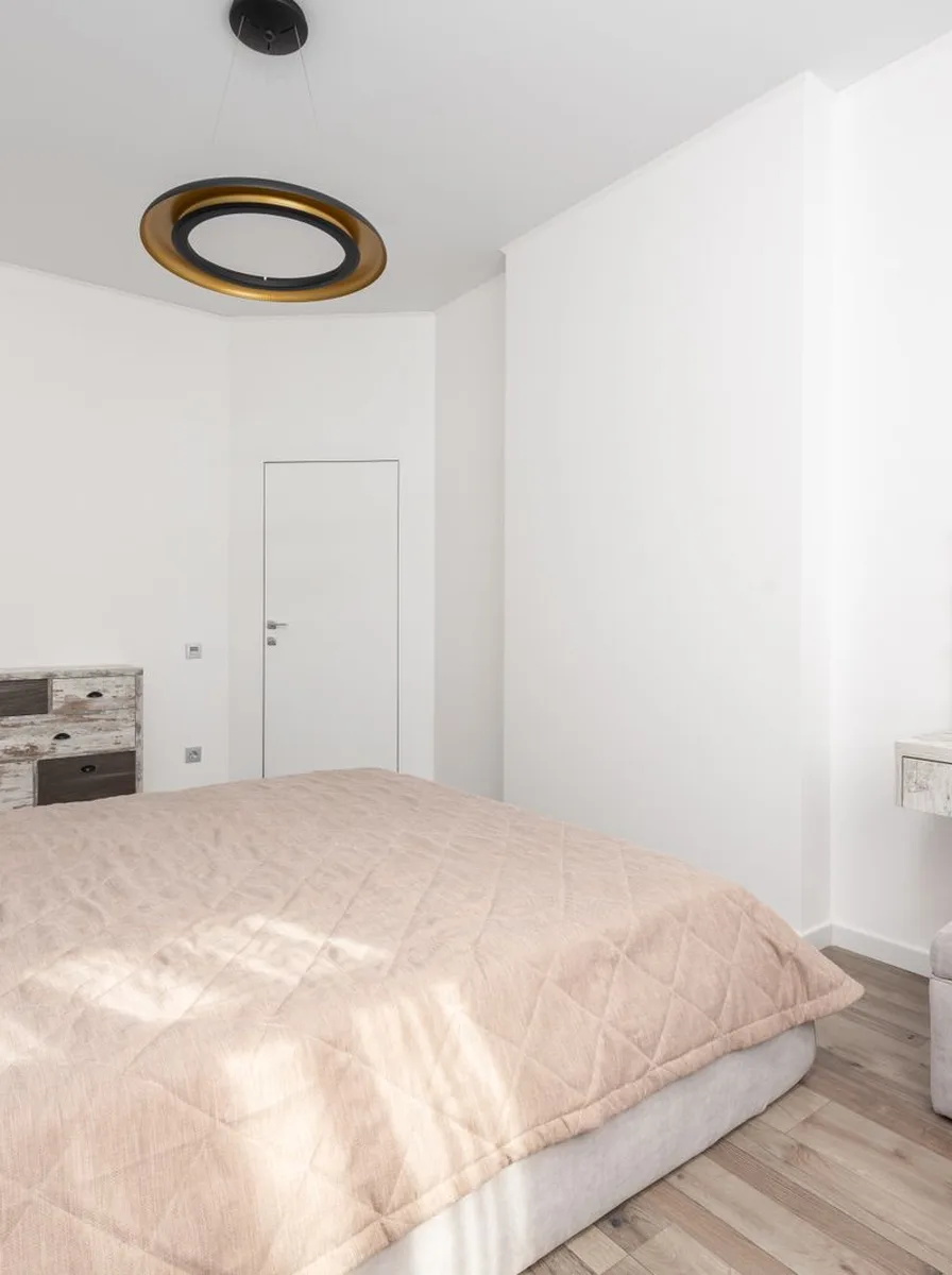 Blush bedroom with round ceiling light