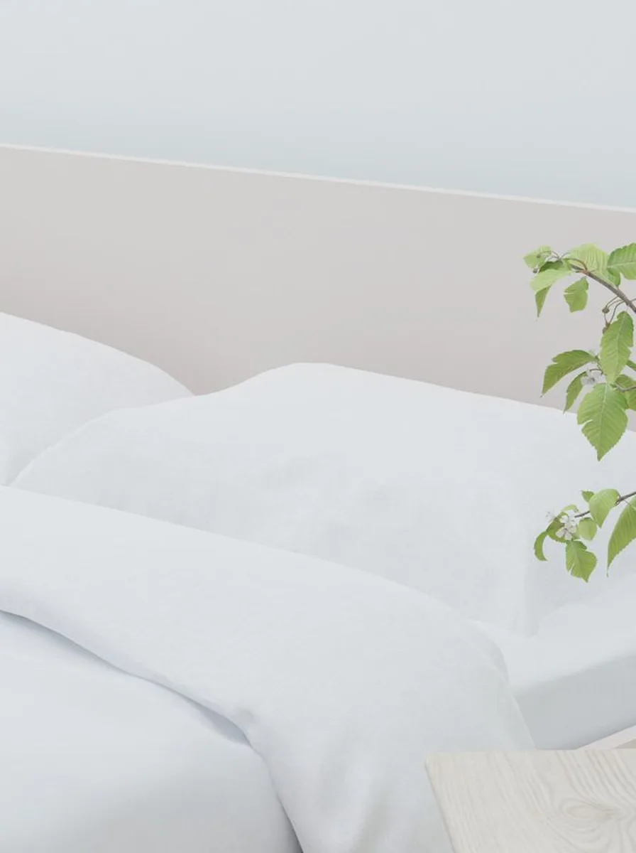 White bed with green plant