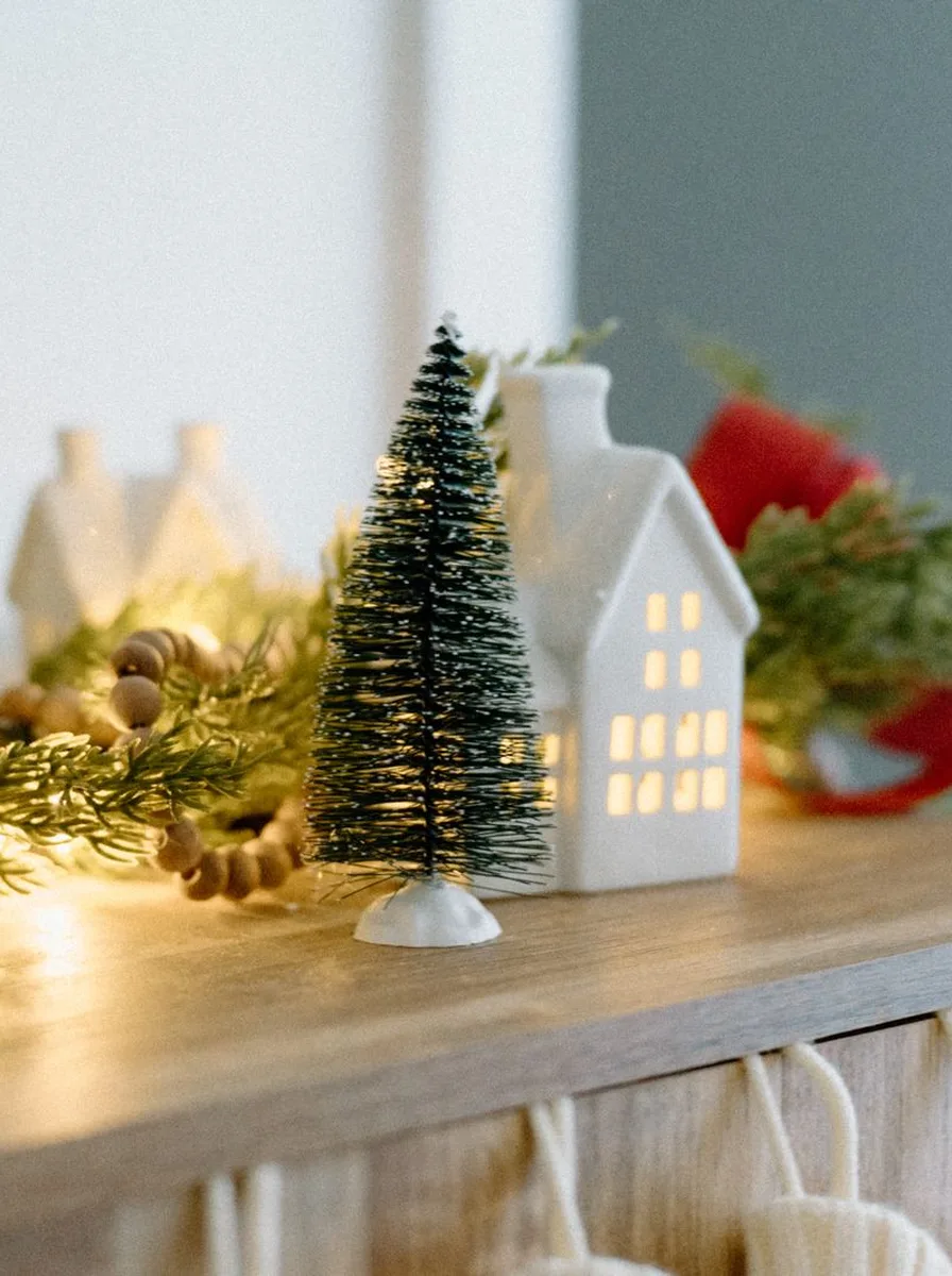 Lit ceramic house with a miniature Christmas tree