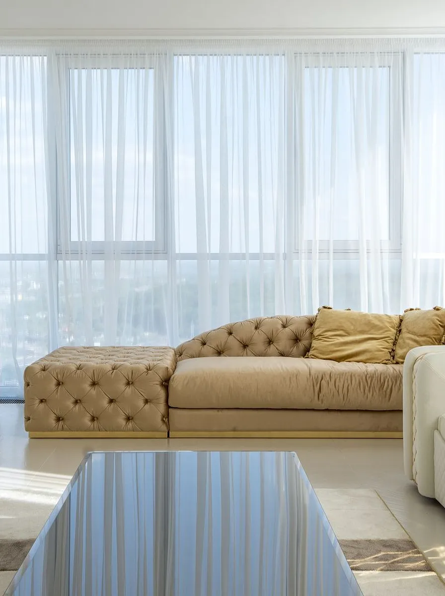 Black and white living room with floor-to-ceiling black curtains