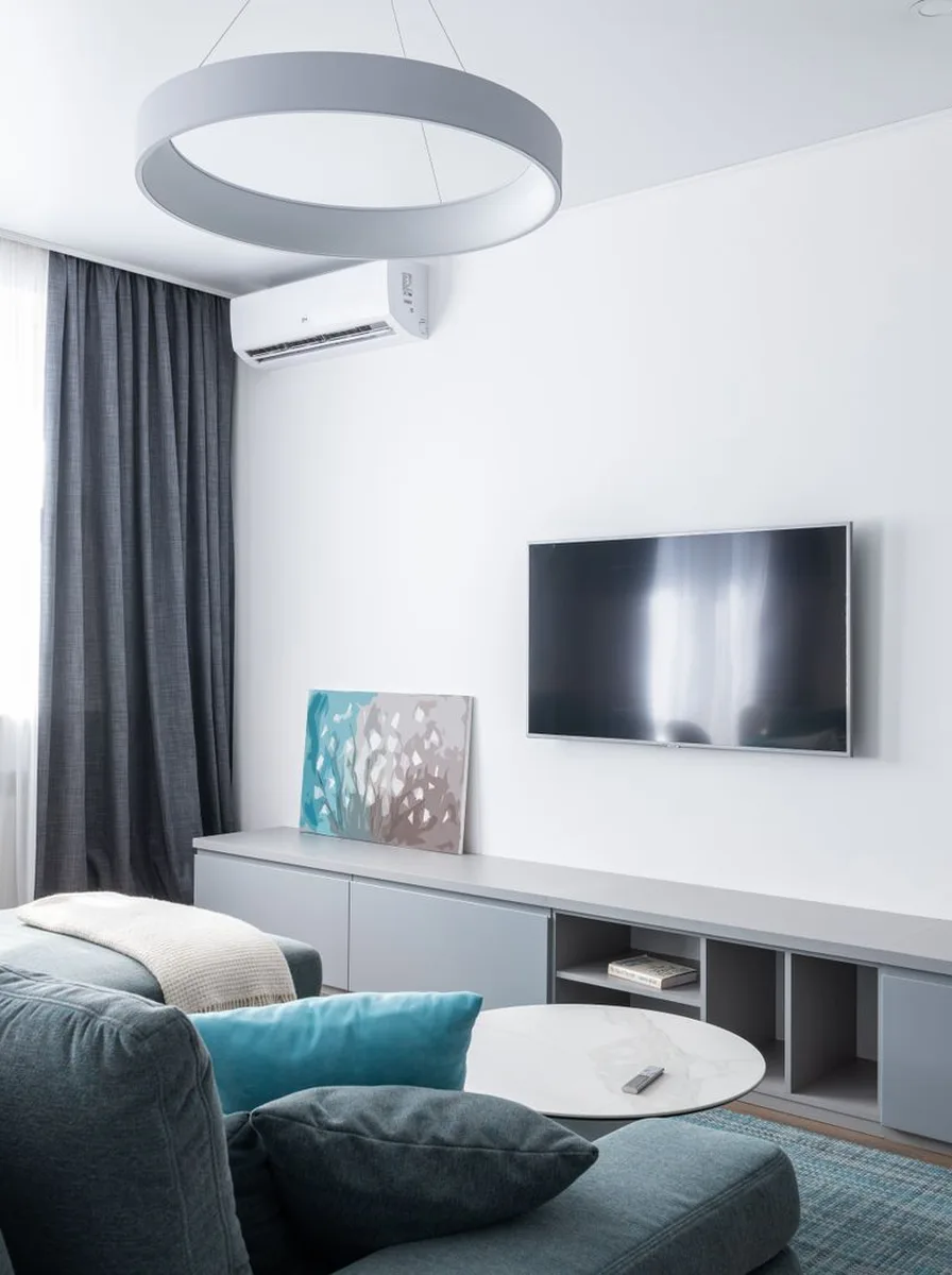 Contemporary TV wall with warm wood slat panelling
