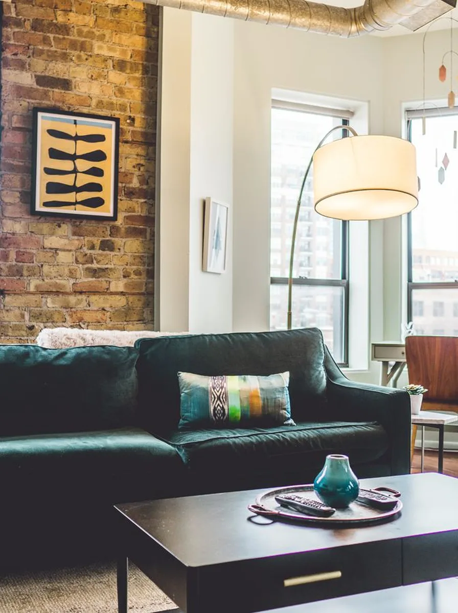 Luxury living room with deep emerald velvet upholstery on sofa and chairs