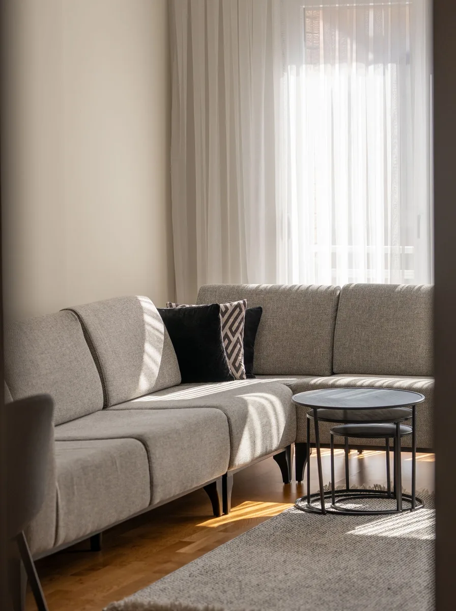Minimalist neutral living room with simple furniture and soft light