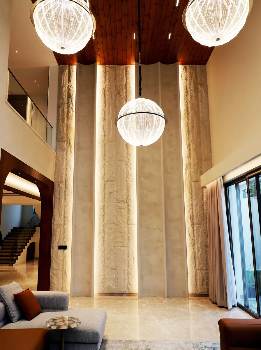 Neutral living room with an elegant crystal chandelier overhead