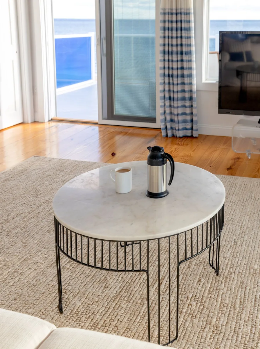 Neutral living room with a white marble coffee table centerpiece
