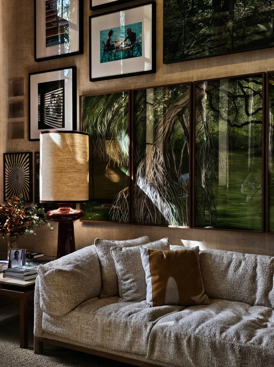 Neutral living room with a gallery wall of warm white framed art