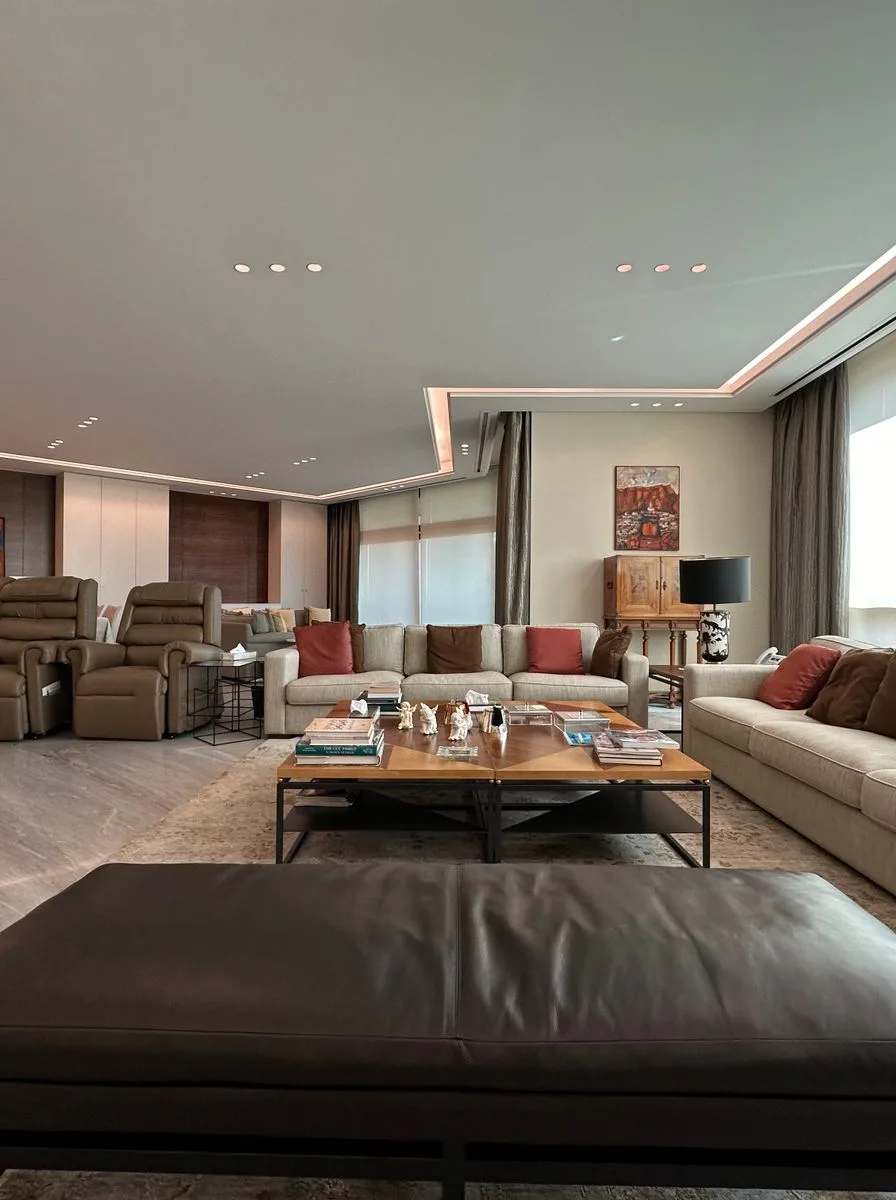 Elegant neutral living room balancing curved chairs with straight lines