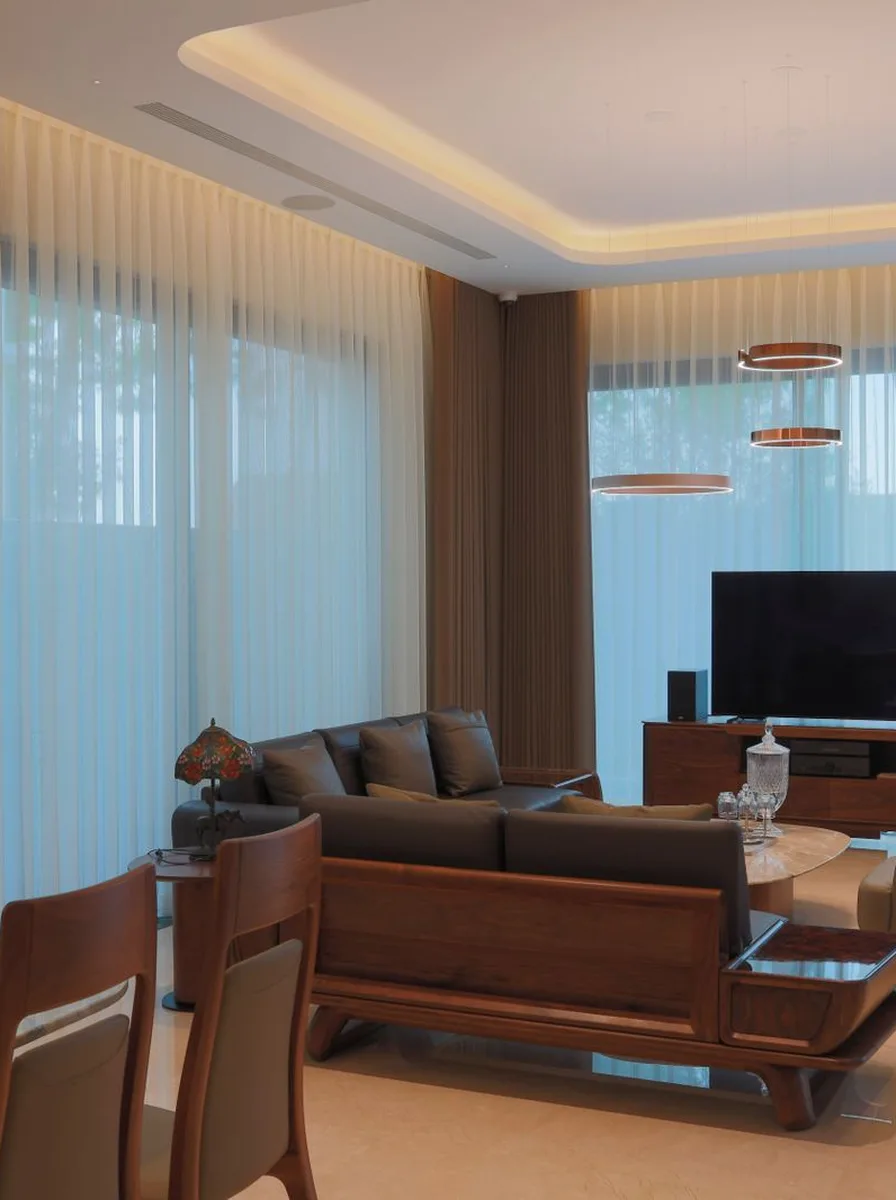 Bright neutral living room with an open wall of tall windows