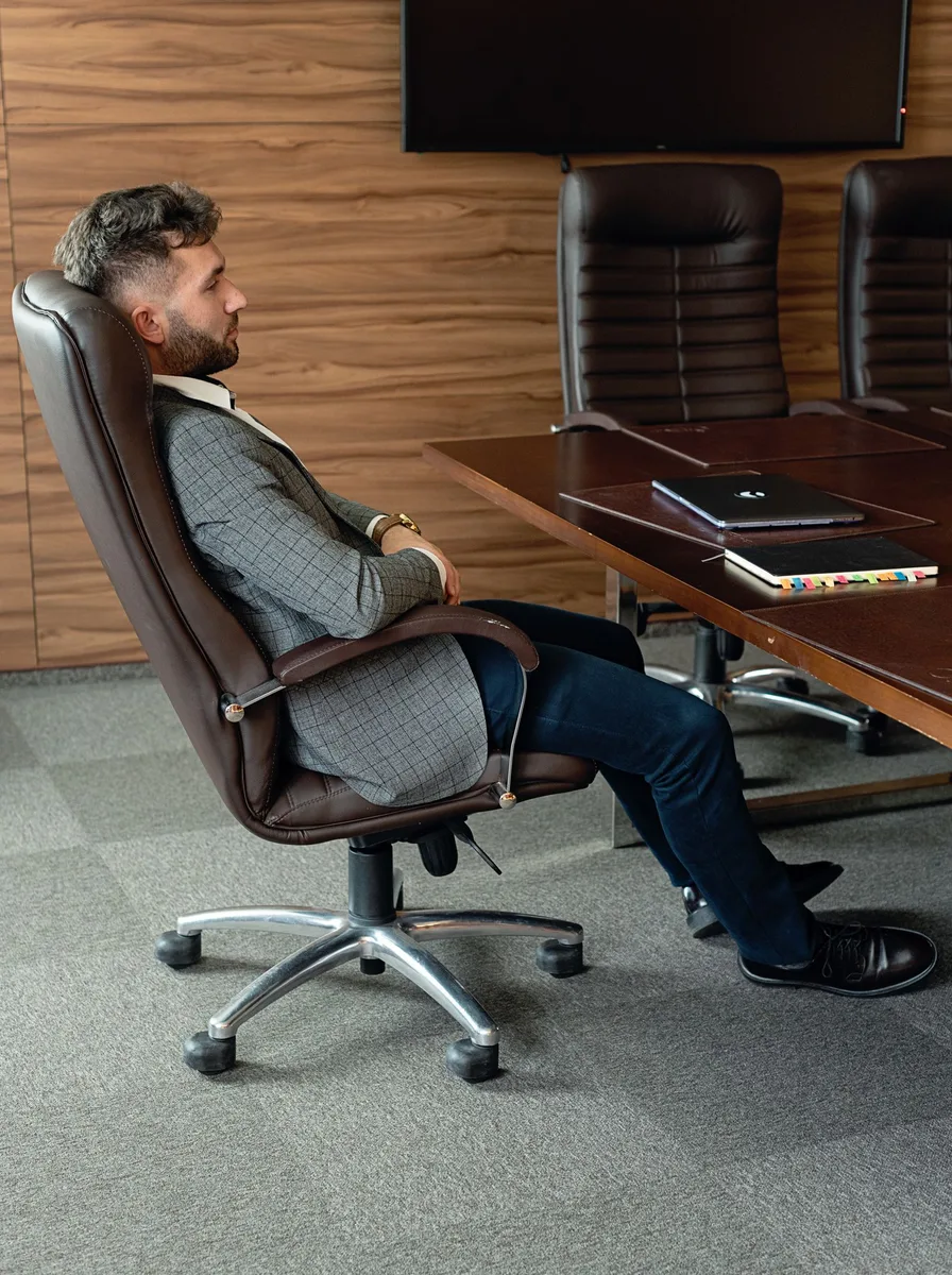 High-back executive office chair at a large desk