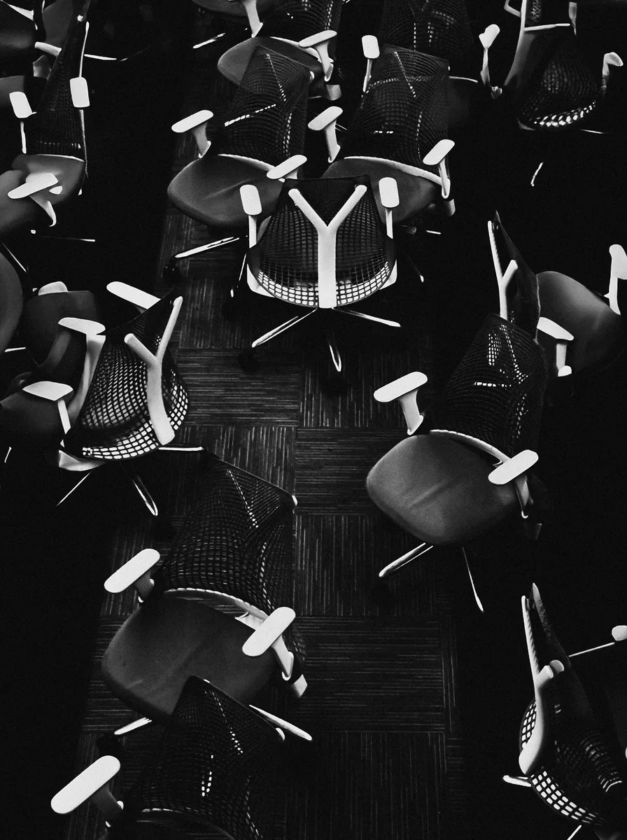 Black mesh office chair in a minimalist office
