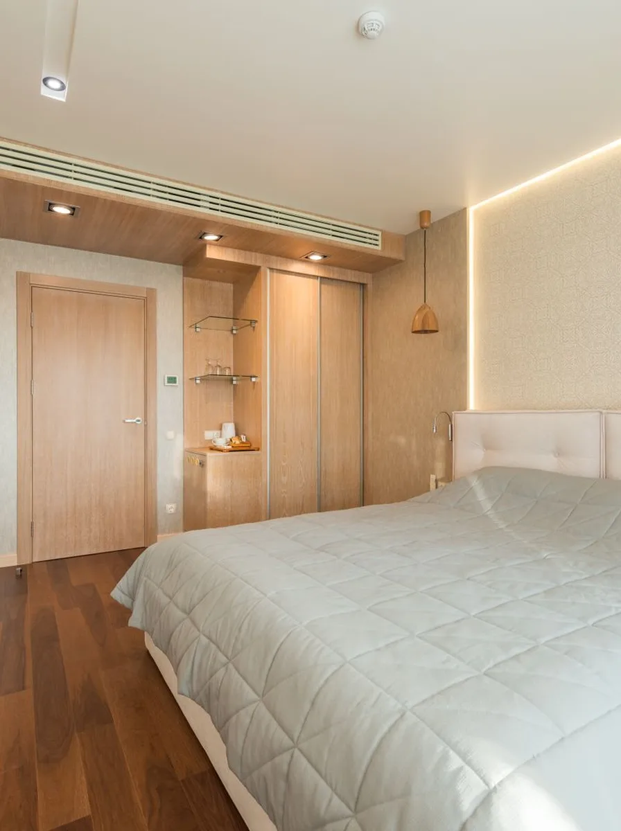 Minimalist bedroom with wall-mounted TV and simple palette