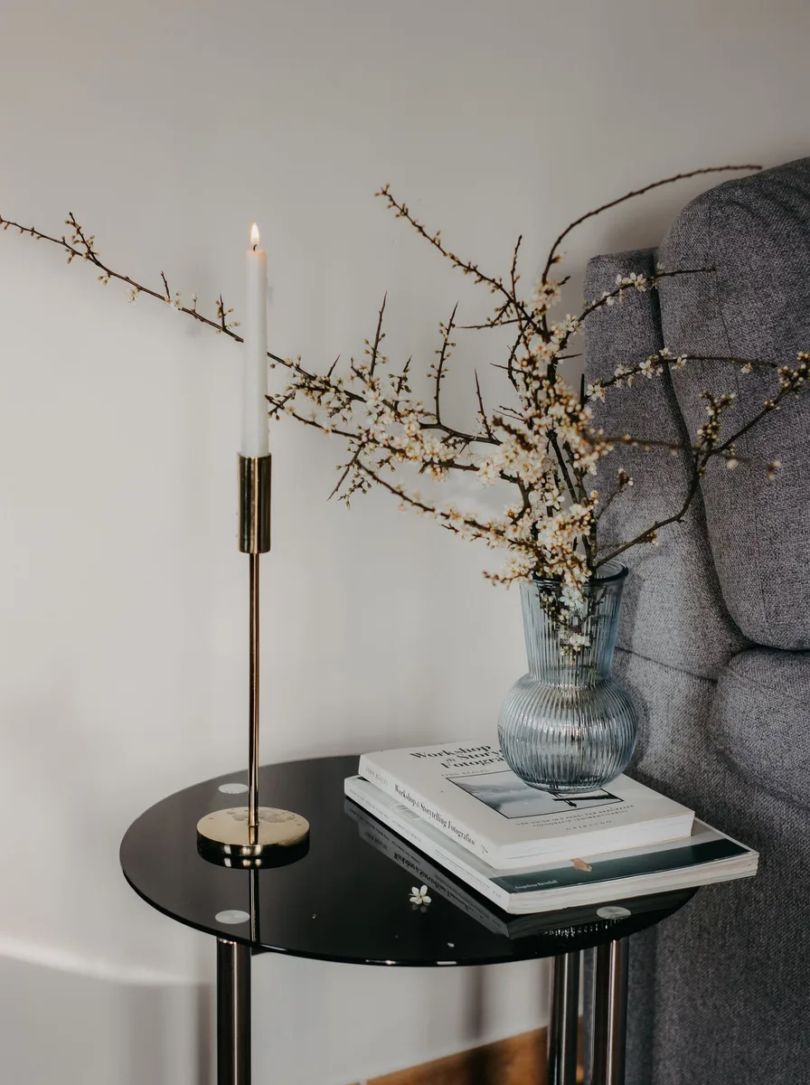 Identical glass candle holders repeated in a row on a dining table